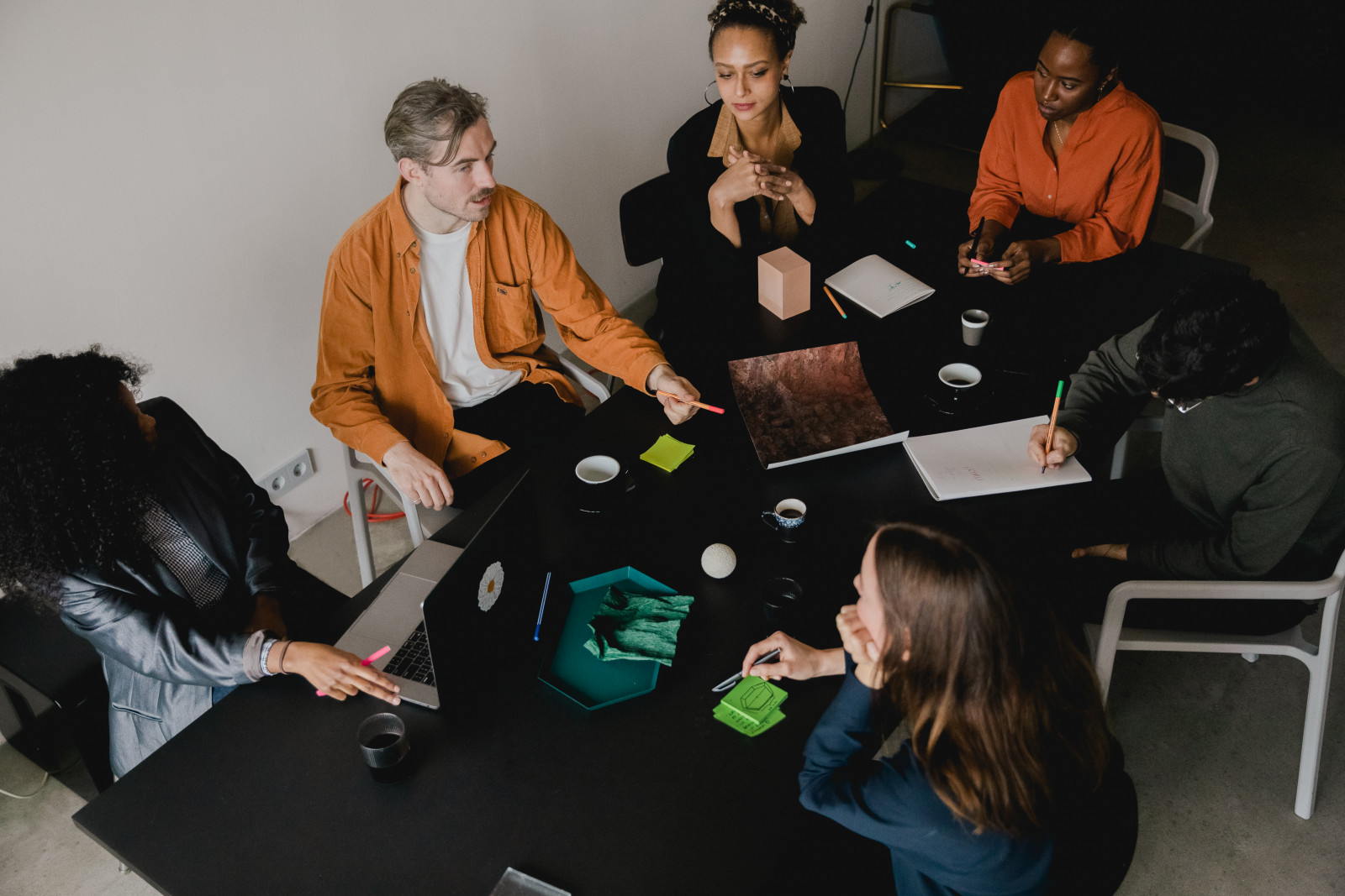 A team seated around a table in discussion